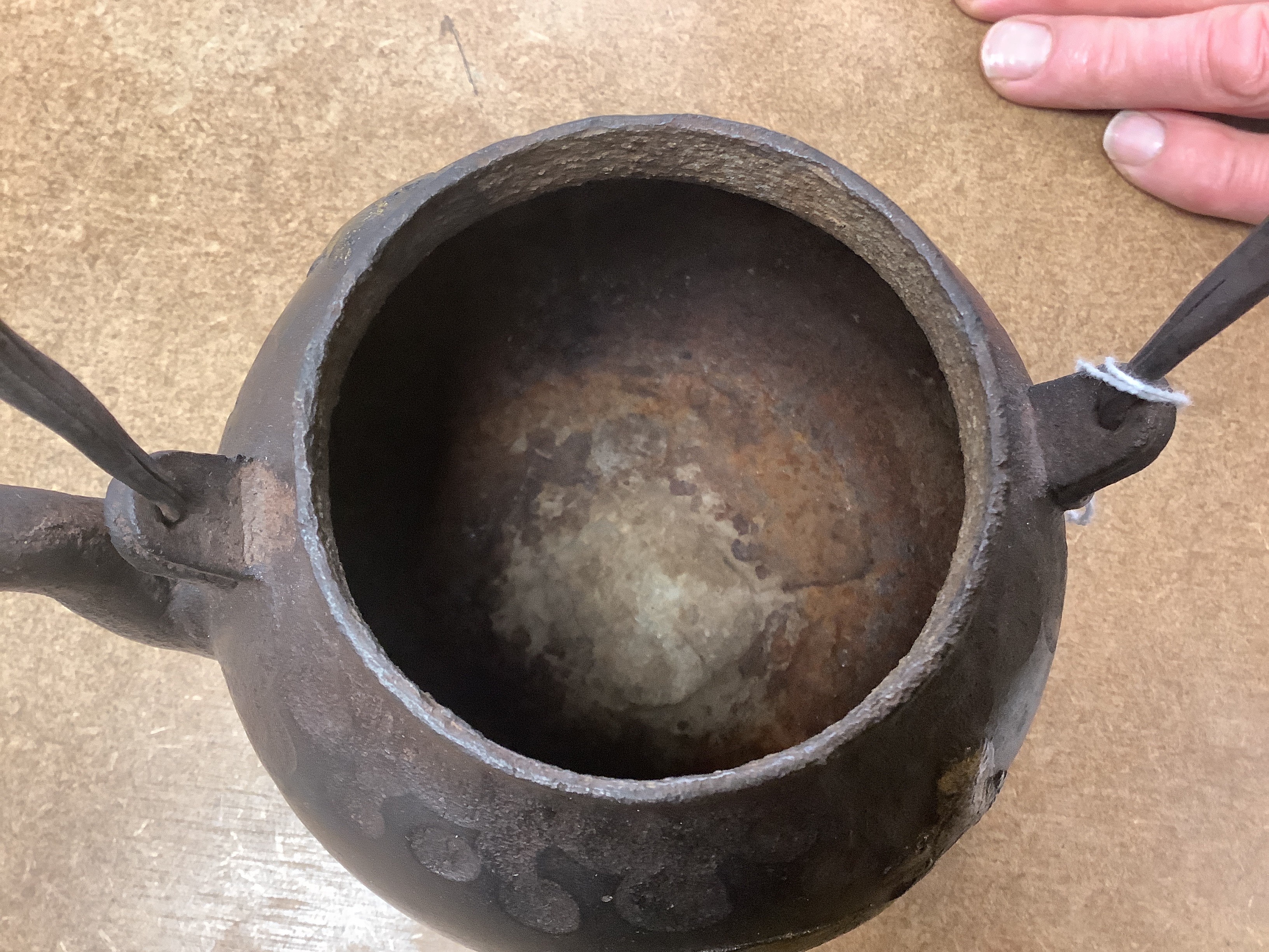A Japanese iron tetsubin kettle with gilt decoration, a pair of Chinese cloisonné enamel vases, 12.5cm, a lacquered box with mother of pearl inlay, a carved black stone disc, 5cm diameter, a miniature ceramic pot and an